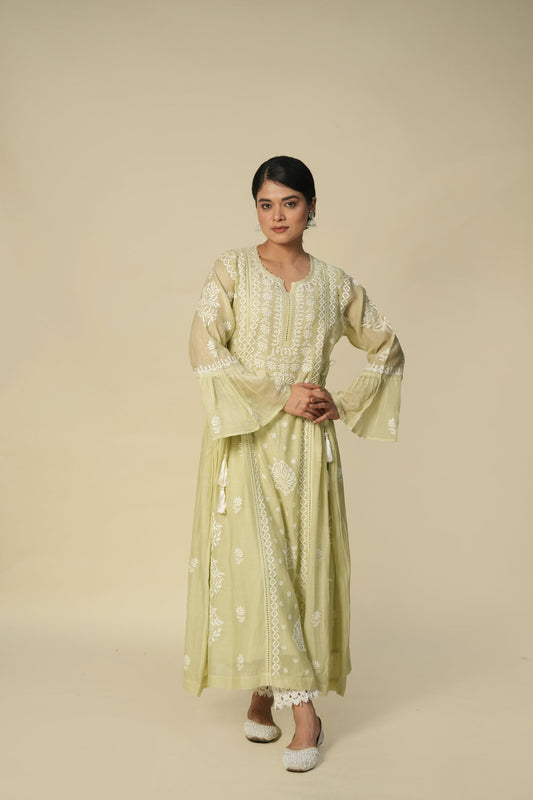 A woman wearing a green floral print kurta set with chikankari work