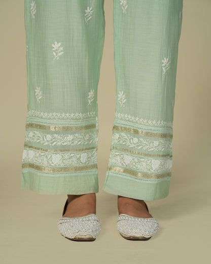 Close up of model wearing green chikankari and chanderi palazzo pants.